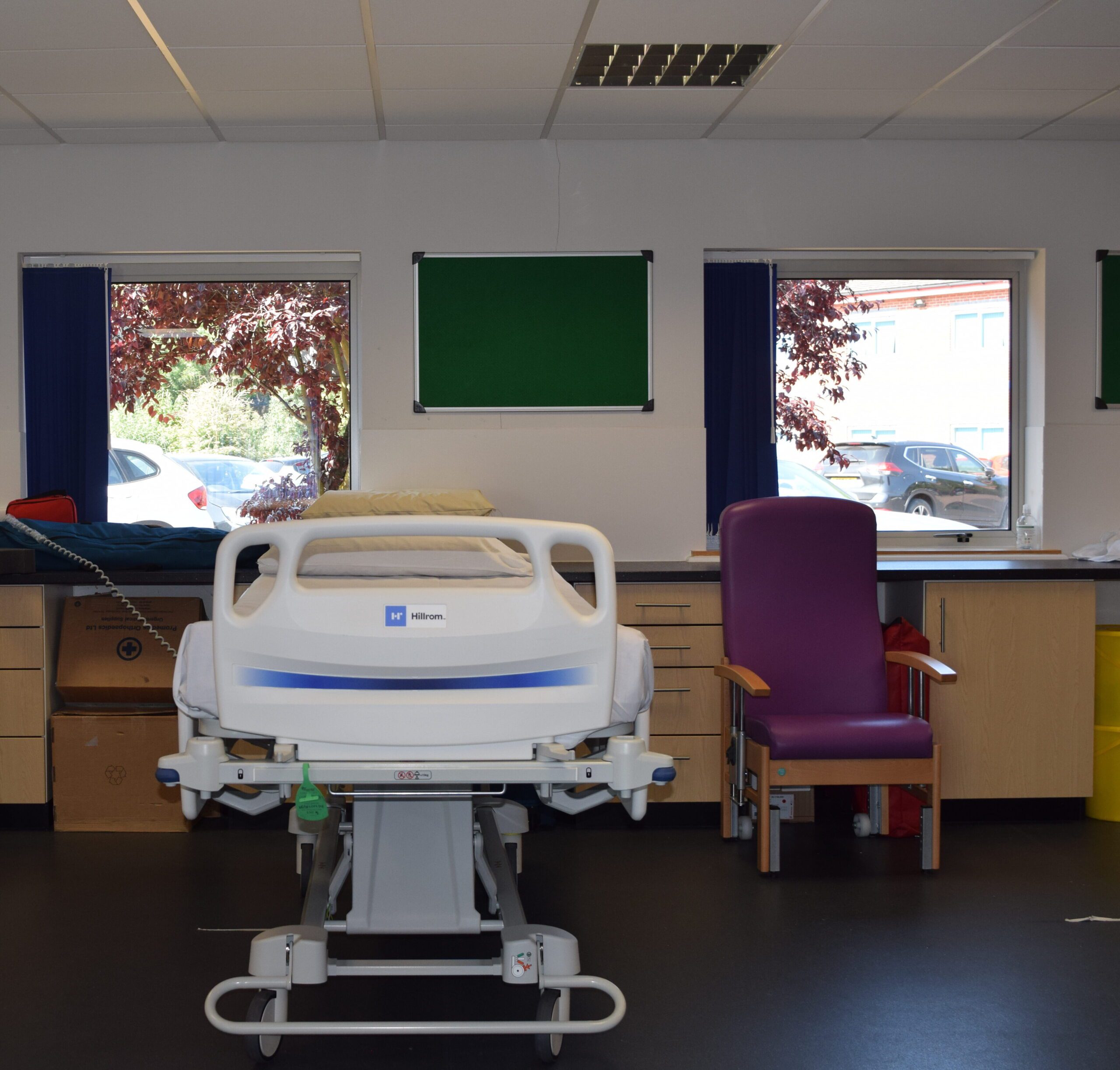 An image with a hospital bed and ergonomic chair